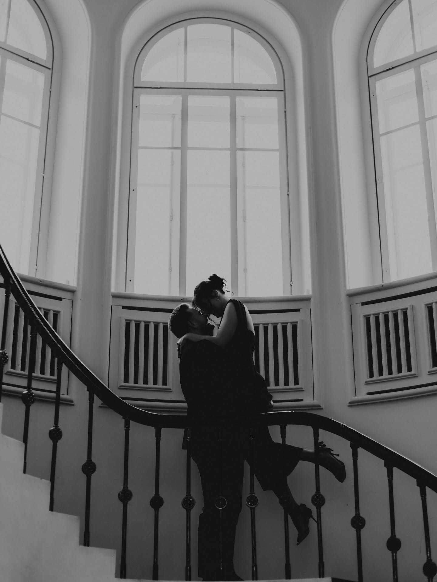 Katrin and Andreas embracing on a grand staircase
